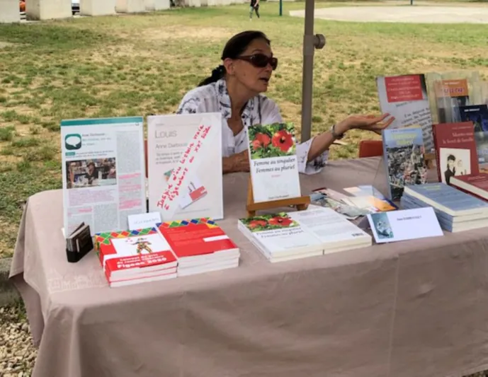 Anne Darbousset à son stand de livres